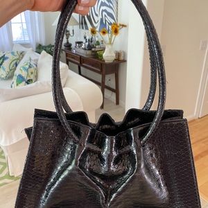 Hand designed leather skinned black handbag.